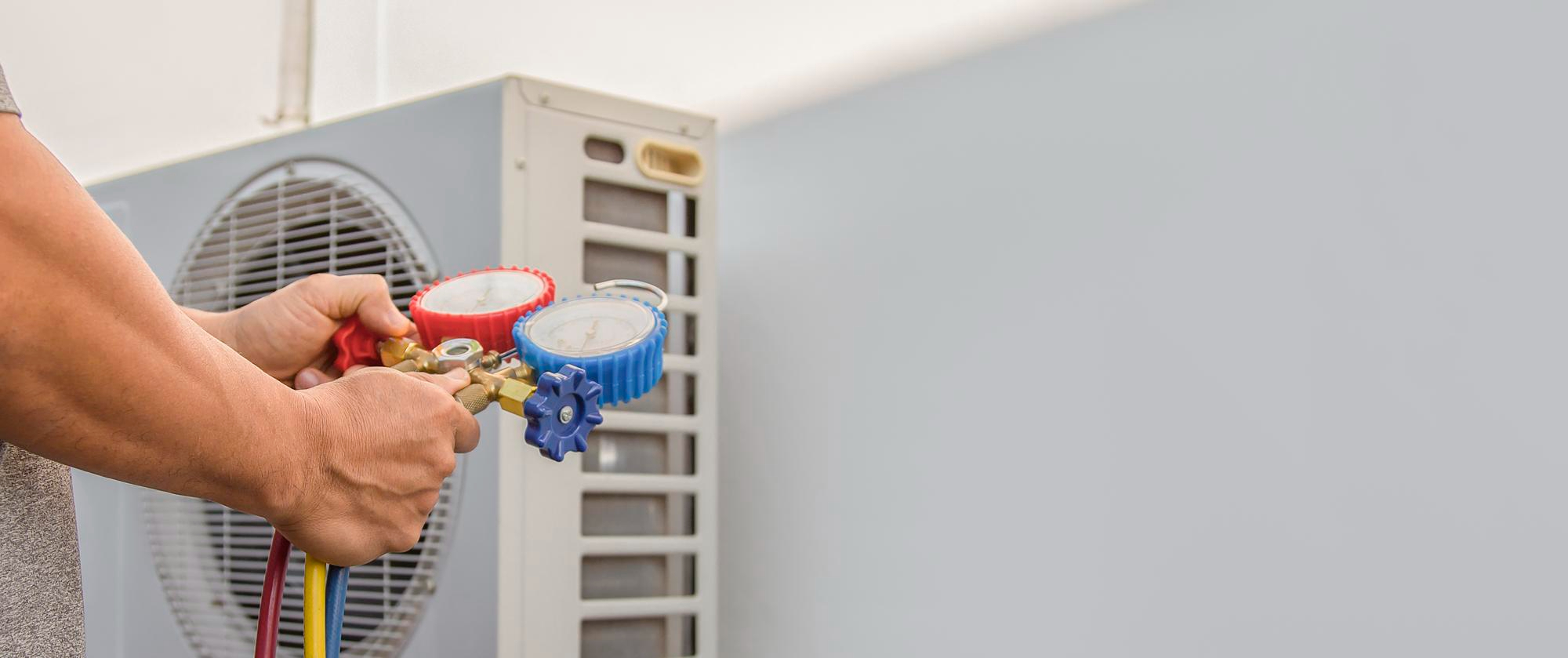 A&D HVAC technician repairing an air conditioning unit in Sandy Springs, GA